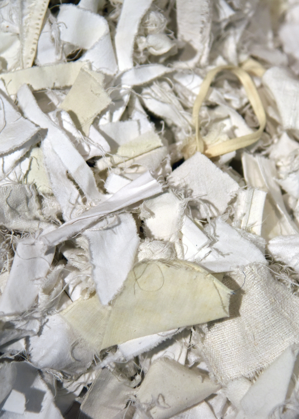 undyed textile scraps in a pile