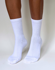 model on toes wearing white crew organic pima cotton socks that are ethically and sustainably made in Peru