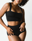 high rise black briefs in tencel, front view on model. hits above navel.