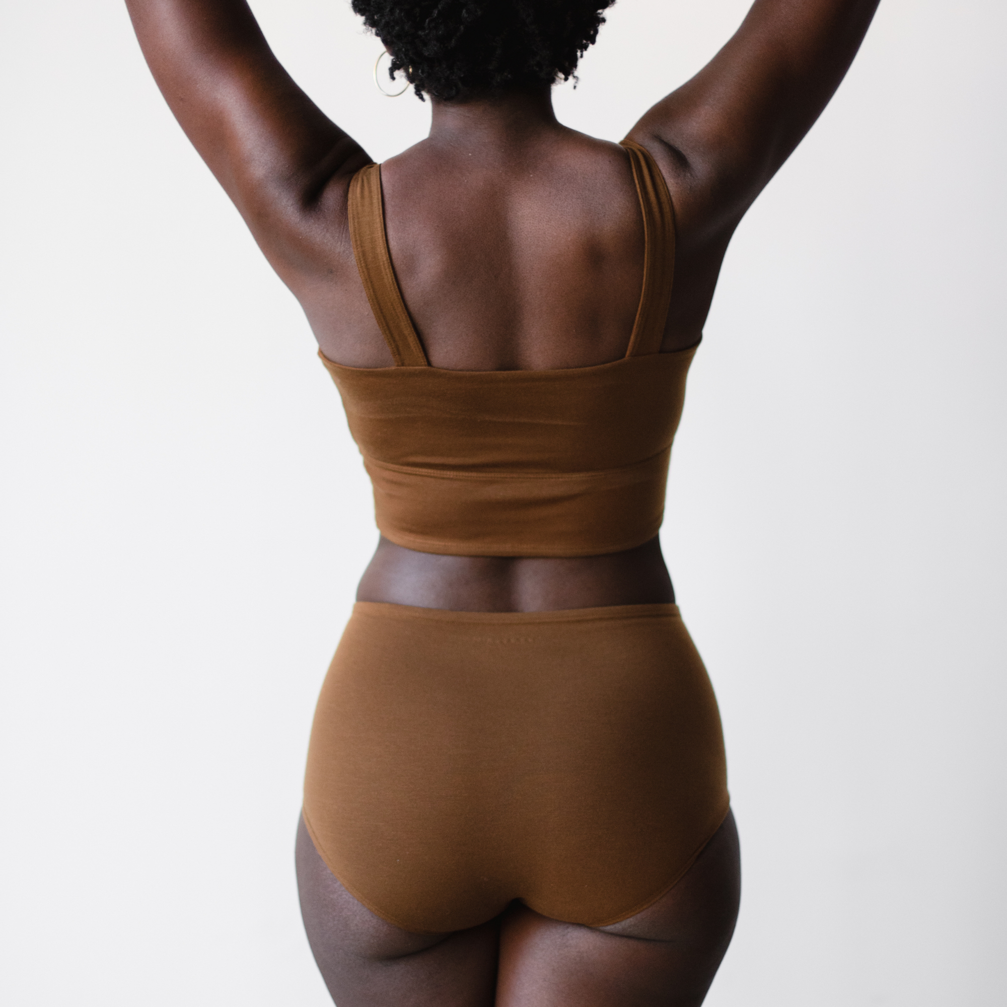 ella nude, a deep brown nude tone, high rise briefs rear view.