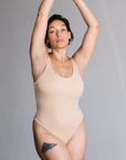 Front view of model in Tencel bodysuit in Ada nude, a beige tone